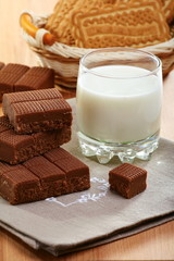 Toffee and a glass of milk on a linen napkin.