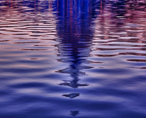 Sunrise behind the dome of the Capitol reflected in water