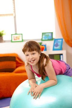 Portrait of young girl with gym ball