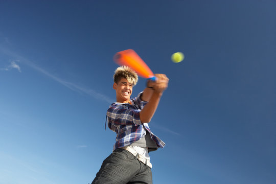 Boy Playing Cricket On Beach