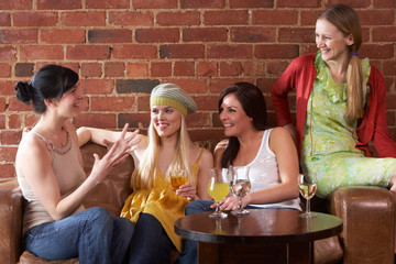 Young women sitting together and talking