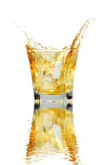 Splash of whiskey with water reflection.