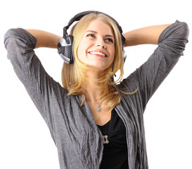 Pretty young girl enjoys listening music