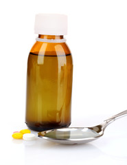 Spoon of cough medicine and bottle  isolated on  white backgroun