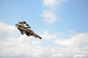 Fotobehang Motocross rider on motorbike efficient flight © VVKSAM