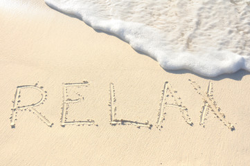 Relax Written in Sand on Beach