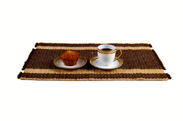 cake with a cup of coffee on the mat