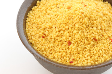 Brown bowl with couscous on white background
