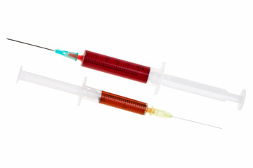 Fototapeta premium Two syringes with red liquid isolated over white background.