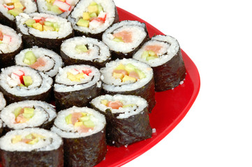 Japanese cuisine - sushi roll on red plate on white backround