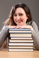 Beautiful happy student sitting with study books