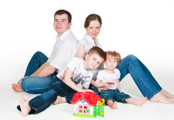 Happy family near a toy small house