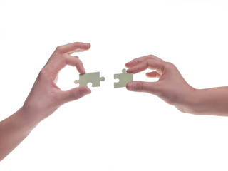 Hands holding puzzle pieces