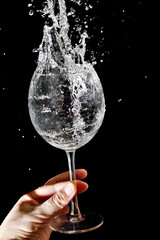 The stream of water pours into the glass