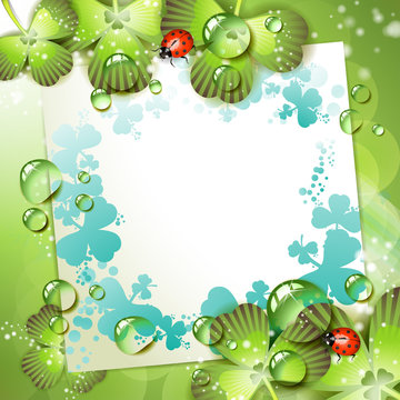 Sheet of paper and clover over springtime background