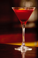 A glass with the red citrus cocktail