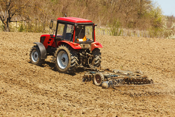 Obraz premium Tractor with disk harrow and rake