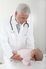 Pediatrician examining baby's good health