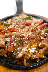 Roasted meat with vegetables on frying pan