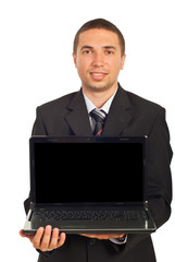 Smiling executive man holding laptop