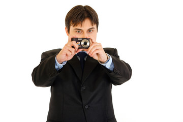 Concentration businessman holding camera and making shot .