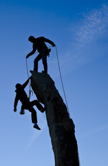 Team of climbers reaching the summit.