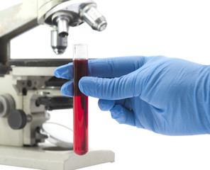 vial of blood in his hand