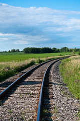 Fototapeta na wymiar Railroad Tracks Curving Off into the Distance