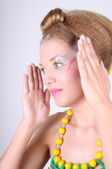 Young woman with creative make-up and coiffure