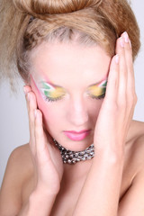 Fototapeta premium Young woman with creative make-up and coiffure