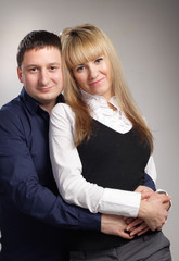 cheerful family couple embrace blond woman