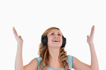 Fototapeta premium Isolated blond-haired woman happy while listening to music