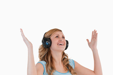 Cute blond-haired woman enjoying while listening to music