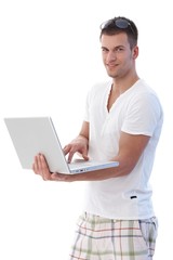 Young man using laptop smiling