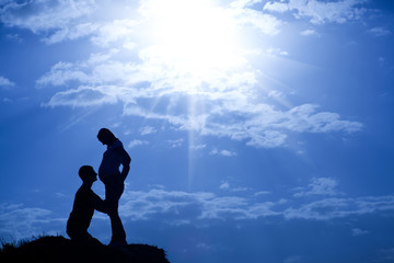 silhouette of man and pregnant woman