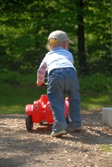 Child with bobby car