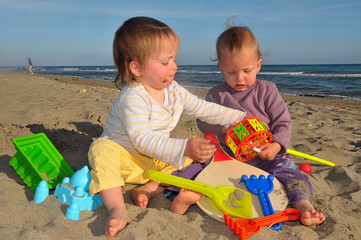 twin sister quarreling at beach