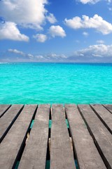 Caribbean wood pier with turquoise aqua sea