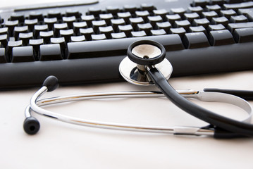 A stethoscope and computer keyboard