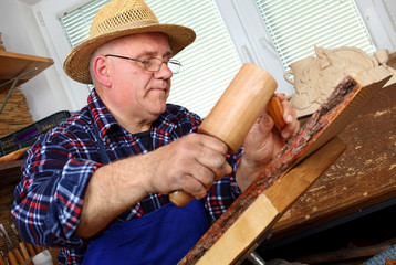 Woodcarver work in his workshop