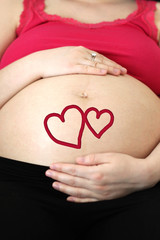 Pregnant girl hugs her future love hearts
