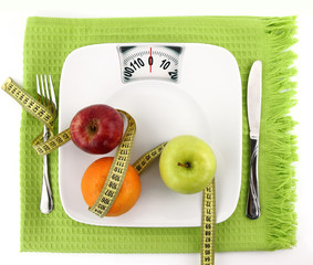Fruits with measuring tape on a plate like weight scale
