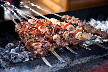 Juicy slices of meat with sauce prepare on fire (shish kebab).