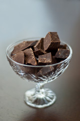 Broken chocolate bar on a wooden table