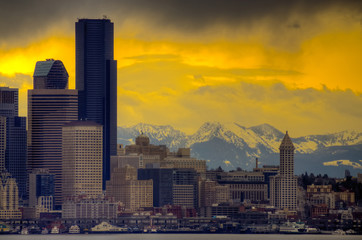 Downtown Seattle with dramatic sky and Cascade Mountains in the