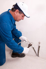 Plumber fixing water pipe
