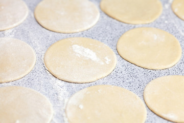 Fototapeta na wymiar round shape of the dough with flour on the table