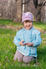 Little smiling girl at forest