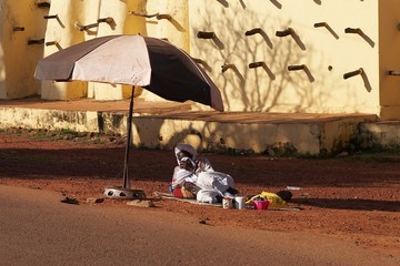 A man resting on an African street