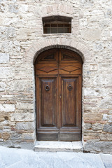 Fototapeta na wymiar Traditional Wooden front door In Italy Tuscany